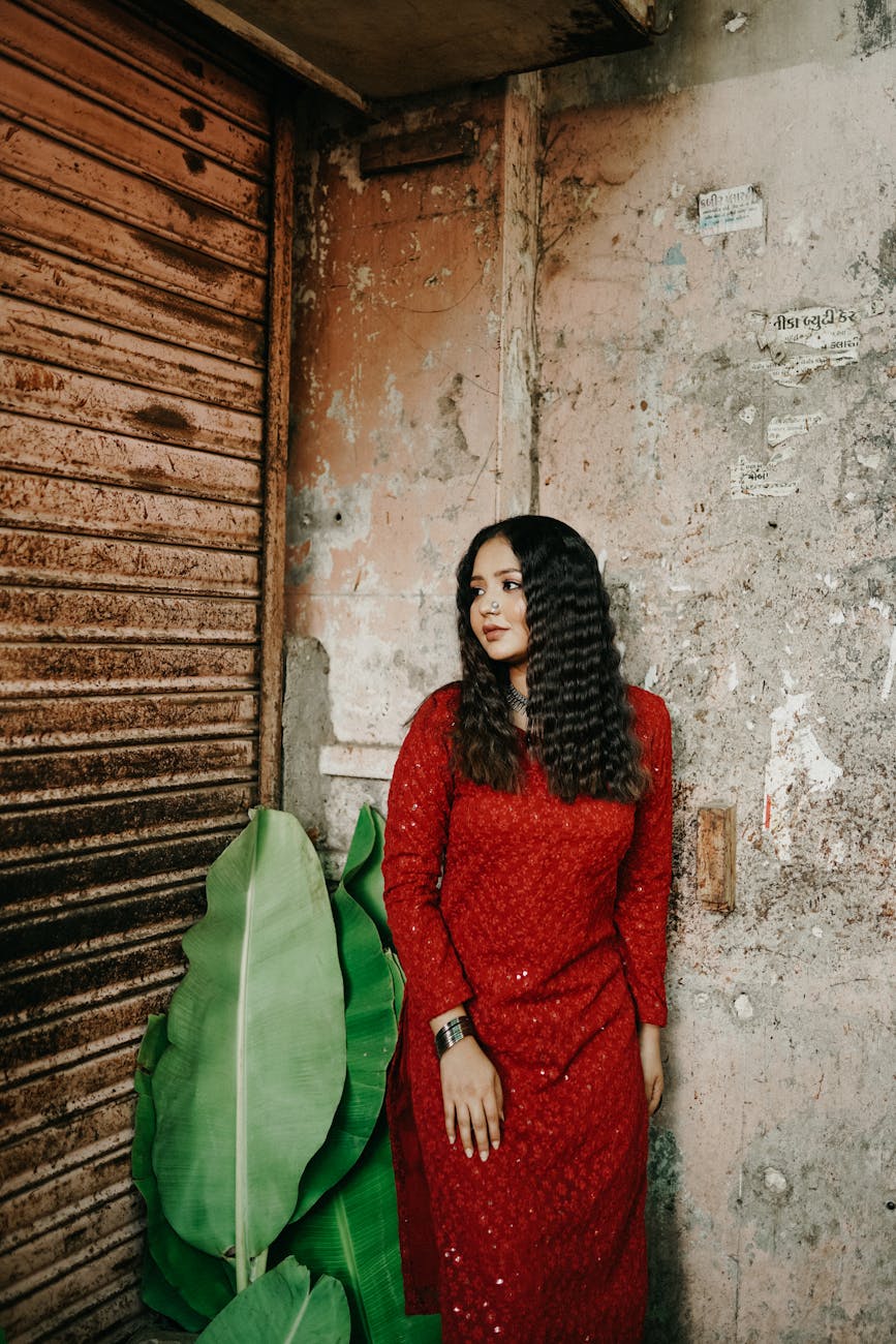 Grunge: The 2026 Era of "Moody Authenticity" at Just For Hair 1 woman posing in red clothes near leaf