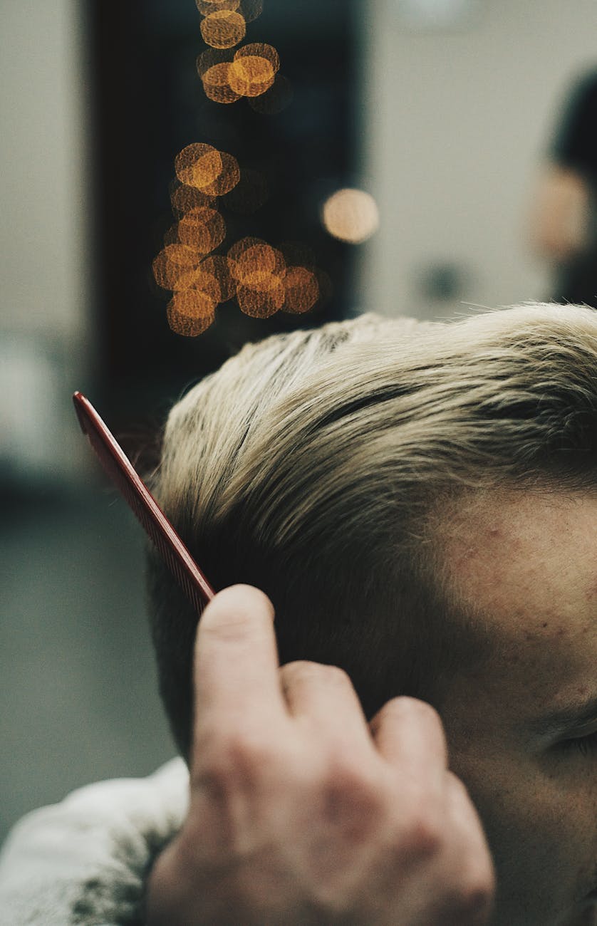 Chief: Leading with Authority and Authenticity at Just For Hair 1 man combing his hair