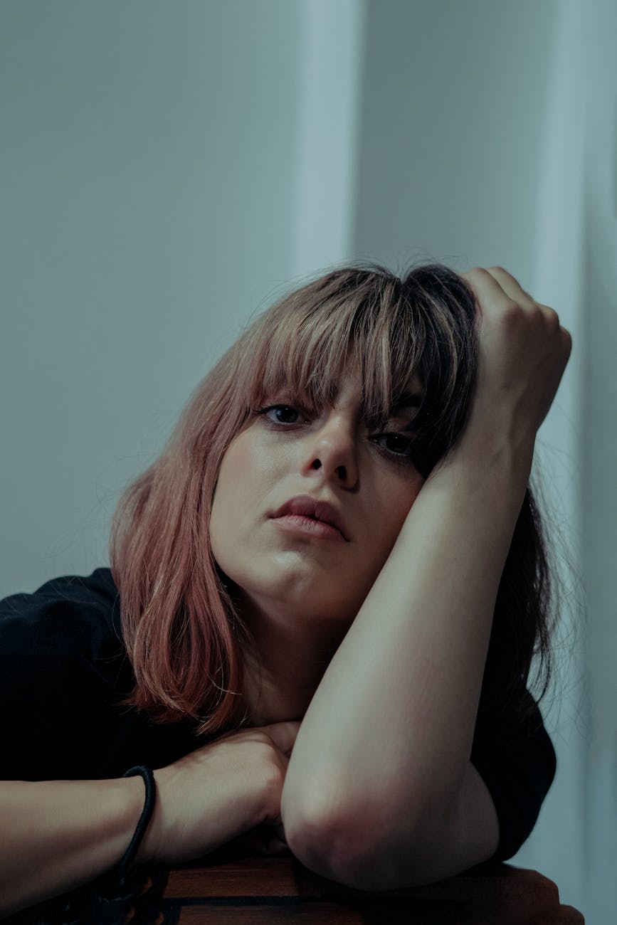 French Girl Fringe: The Timeless Bang at Just For Hair 1 portrait of a young woman propping up on her arm