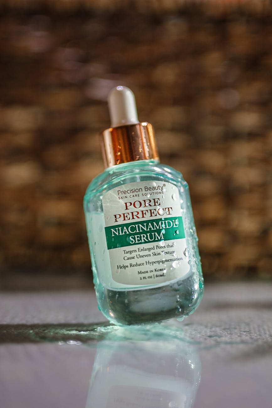 Niacinamide for Hair: Why Your Scalp Needs Skincare Actives 1 pore perfect niacinamide serum bottle on reflective surface