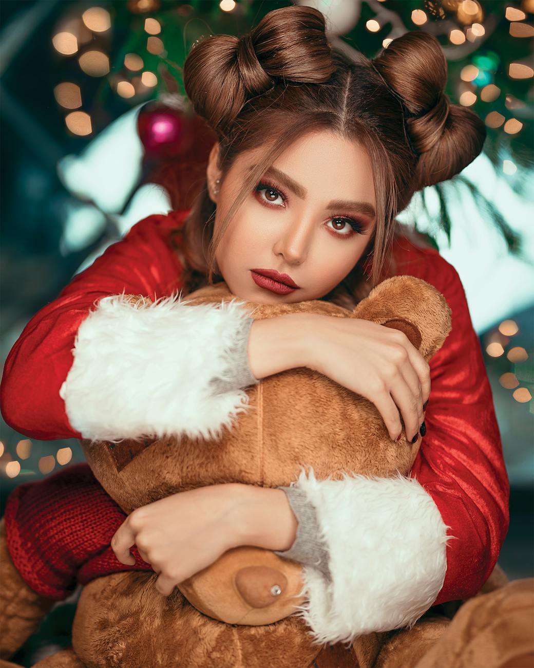 Holiday Hair: Sparkle Without the Stress at Just For Hair 1 woman wearing santa costume while hugging teddy bear