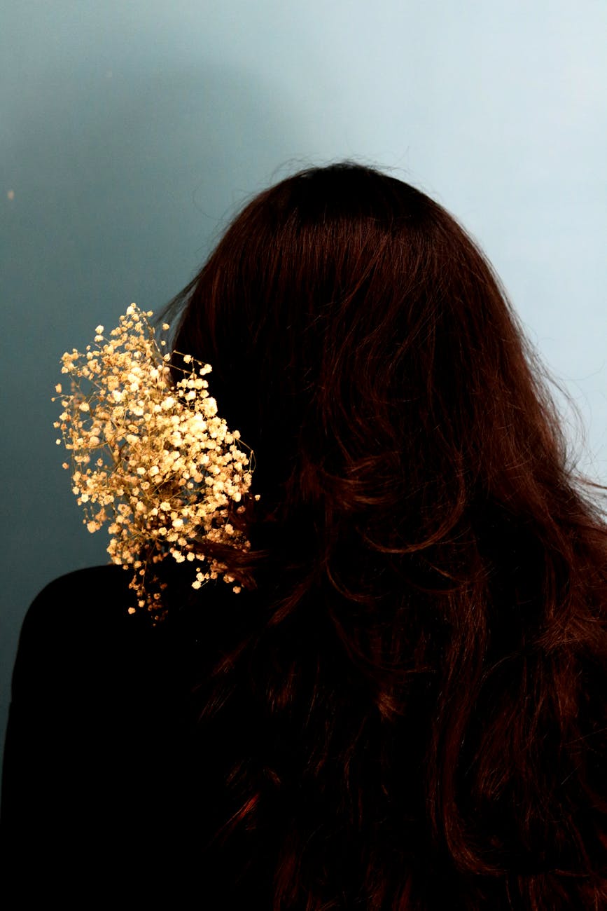 anonymous woman with long brown hair and glitters