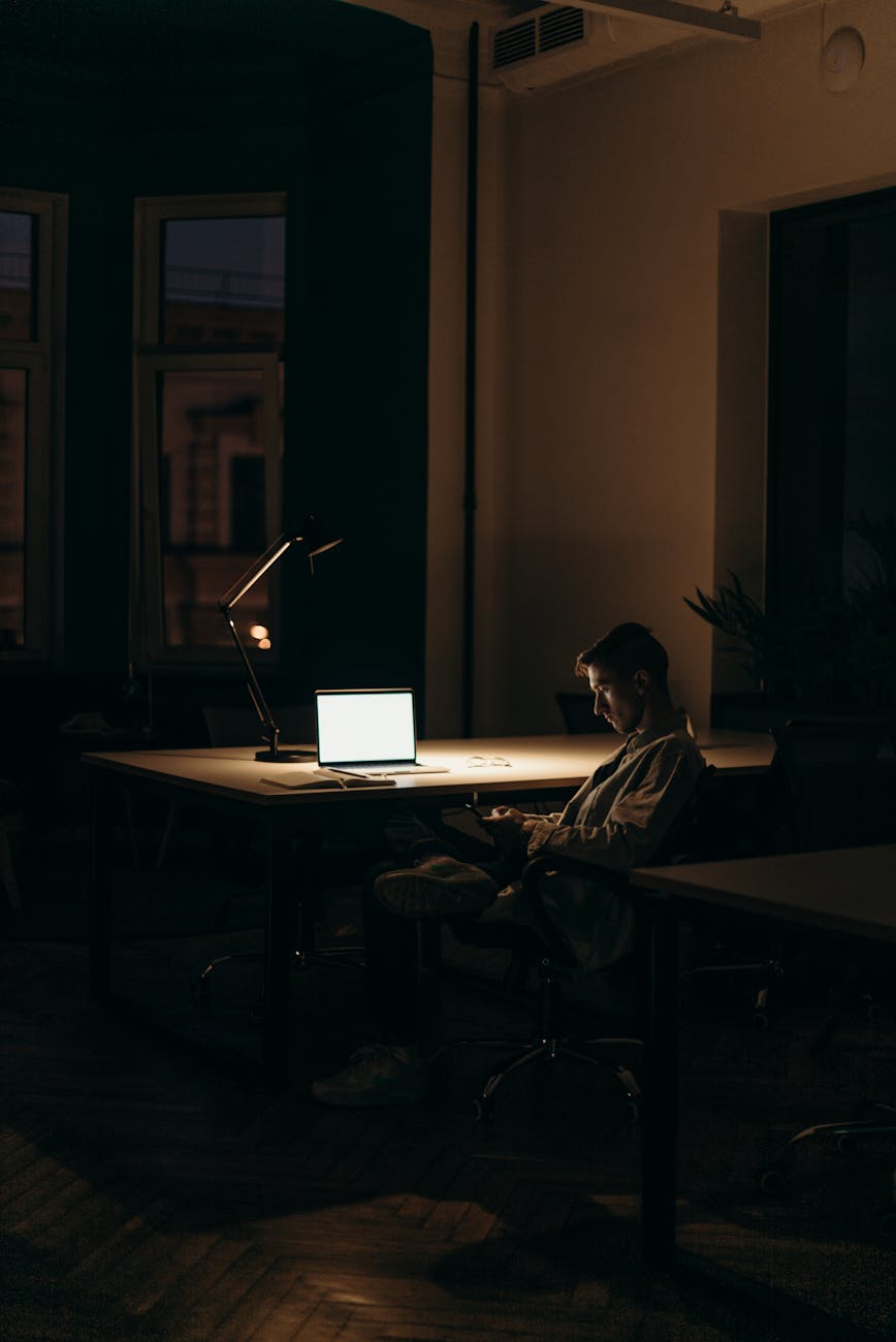 Why Hard Water in Kansas Ruins Your Color (and How to Fix It) 1 man in black and white stripe dress shirt sitting on chair in front of macbook