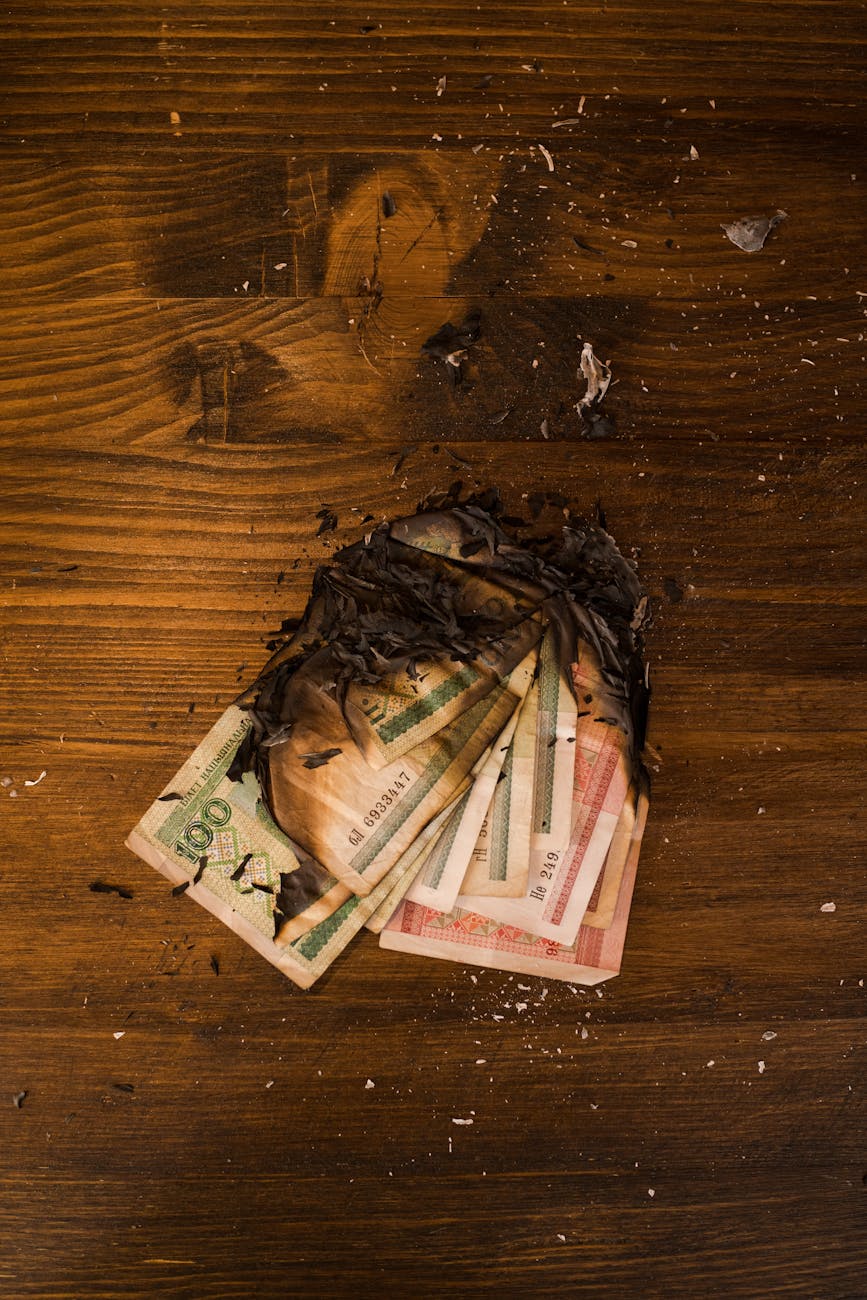 Burnt Blonde: The Dimensional Warmth Your Winter Look Needs 1 burnt stack of banknotes on wooden table