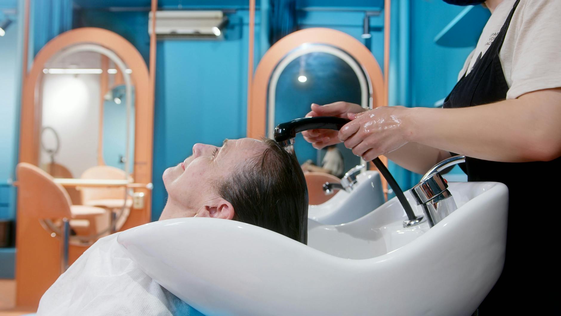 Formula & Fringe: The Art of Personalized Precision in 2026 1 hairdresser washing a client s hair
