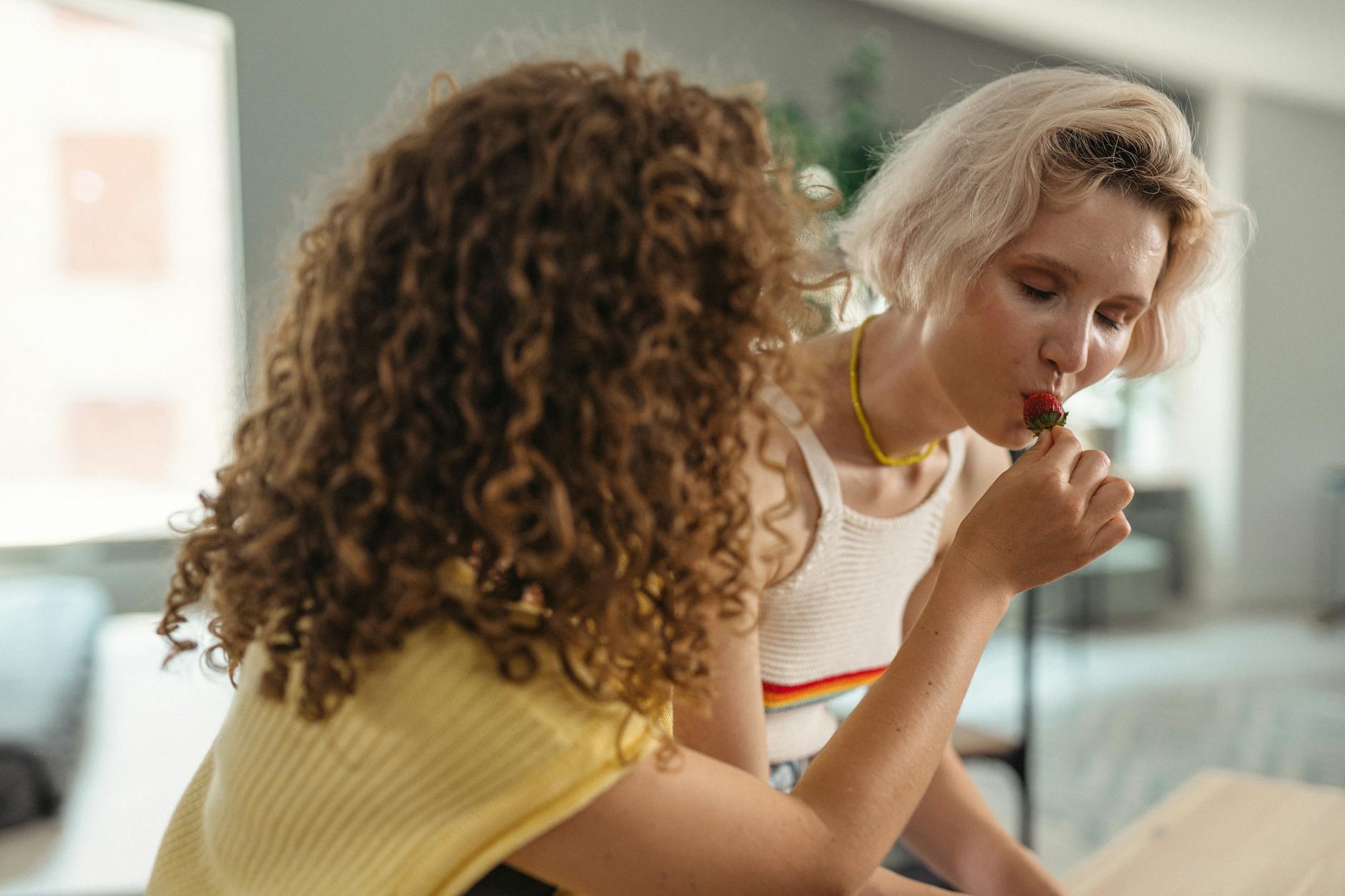 Strawberry Blonde: Finding Your Undertone at Just For Hair 1 a woman eating strawberry