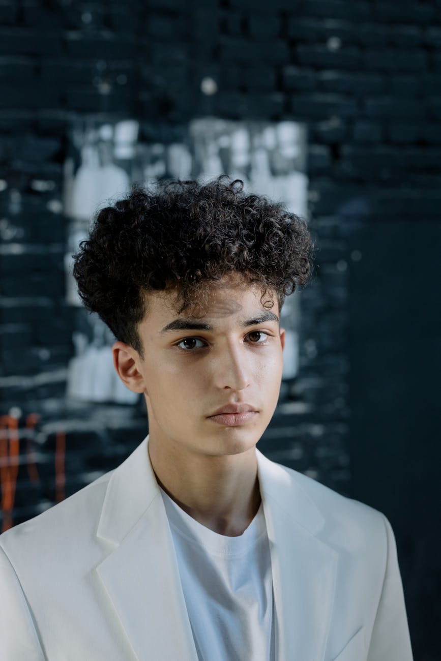 Junior – Teen Styling: The High-Definition Era of Expression at Just For Hair 1 curly haired man wearing white blazer