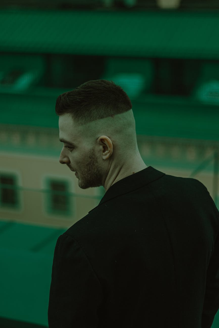 Undercut – Undercut Designs: The Art of the Hidden Detail at Just For Hair 1 young man with half shaved head standing backwards