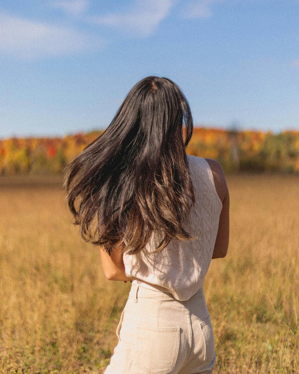 Holiday – Seasonal Styling: Spring Awakening at Just For Hair 1 back view of a woman standing on grass field