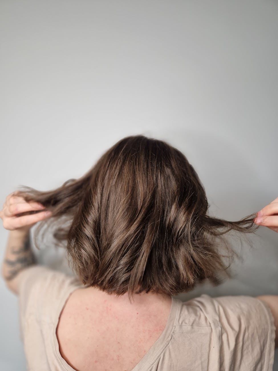 Effortless Radiance: Natural Balayage for Sun-Kissed Hair 1 person holding hair in hands