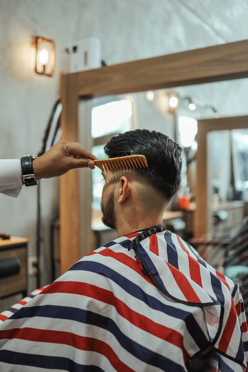 man sitting on barber chair