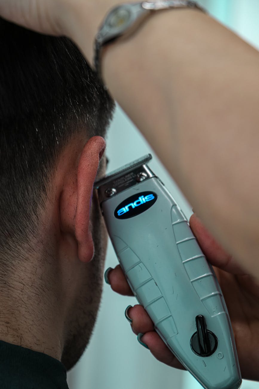 close up of a haircut with trimmer in barbershop