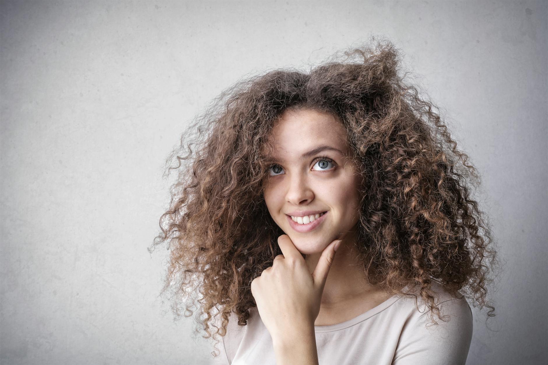 Shrinkage – Shrinkage Control: High-Definition Length at Just For Hair 1 photo of a happy woman