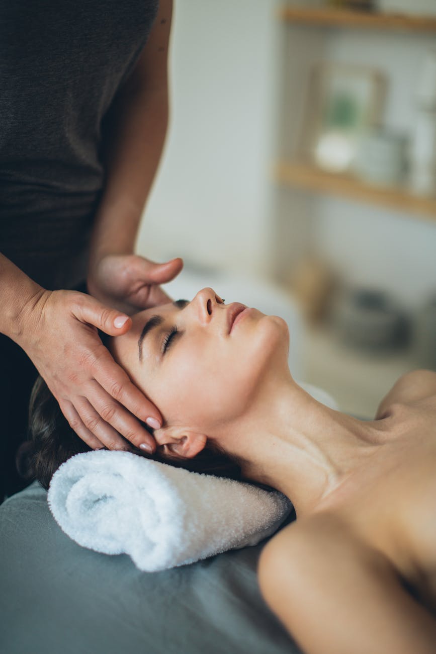 Unwind and Renew: Relaxing Head Massage and Scalp Therapy in Overland Park 1 a topless woman lying down with her eyes closed