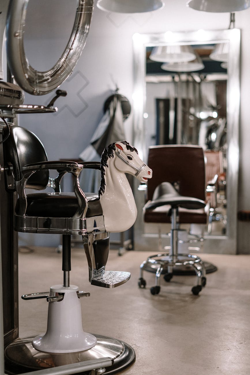 Kids – Children's Cuts: The Next Generation of Style at Just For Hair 1 person sitting on black leather chair