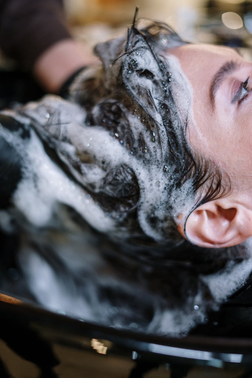 Density – Thickening Treatments: Elevating Your Volume at Just For Hair 1 woman getting her hair shampoo