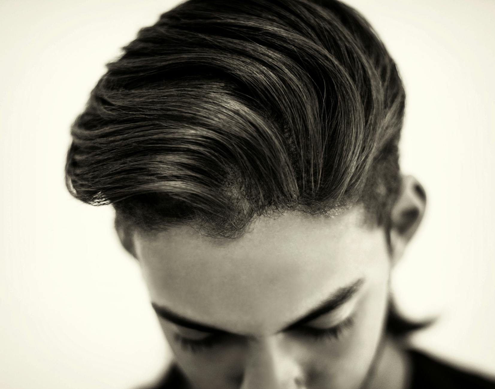 Slick – Slicked-Back Styles: Timeless Command at Just For Hair 1 black and white photo of glamour man hairstyle
