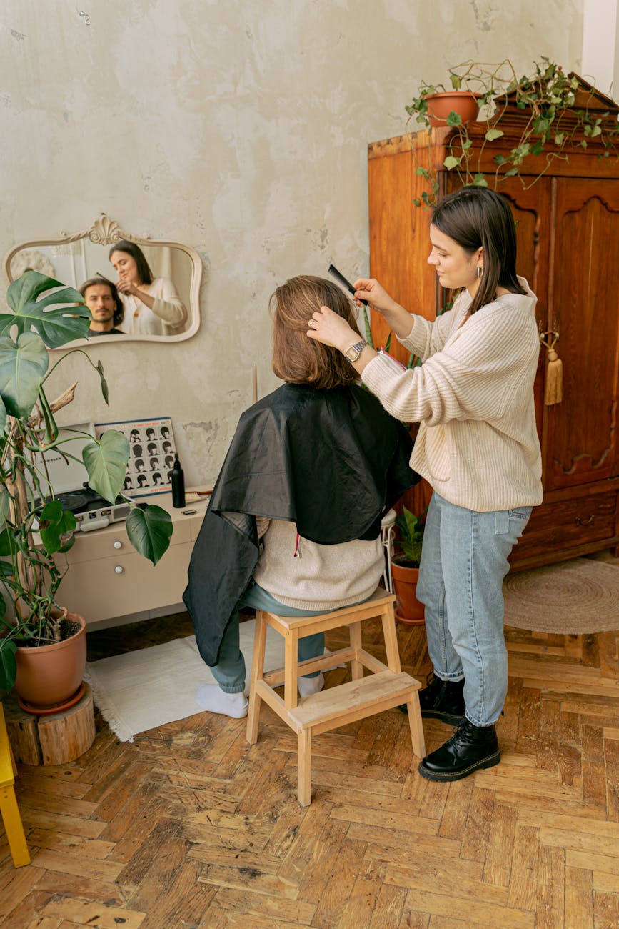 Solution – Problem-Solving Services: The Answer to Your Hair Frustrations at Just For Hair 1 a woman giving a haircut to a bearded man