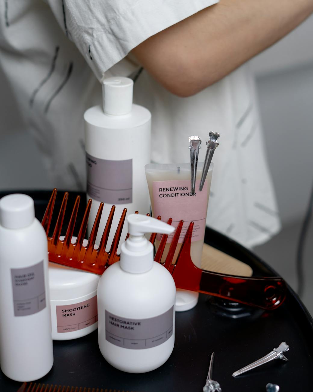 photograph of hair cosmetics on a black surface