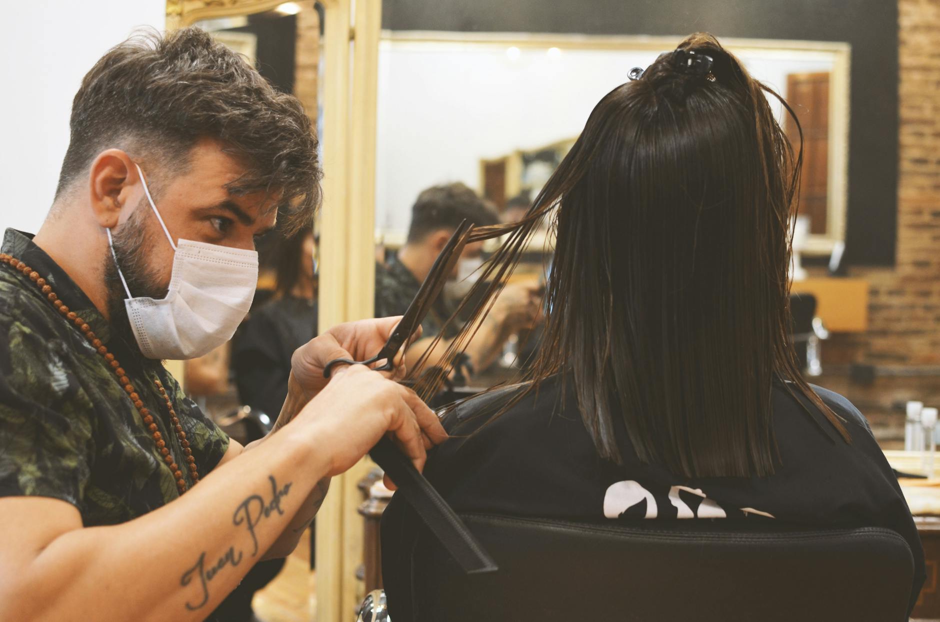 barber cutting the long hair of a person