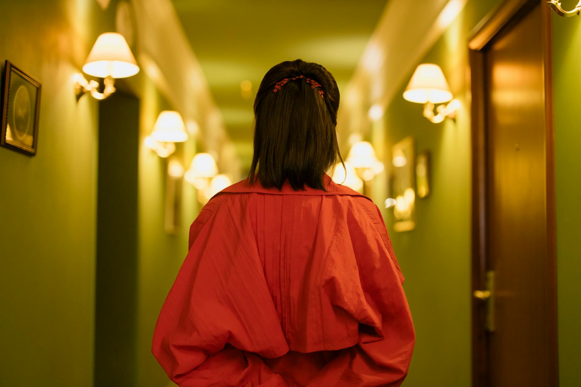 Red Carpet – Celebrity Looks: The Award-Season Standard at Just For Hair 1 woman in red dress standing in the hallway