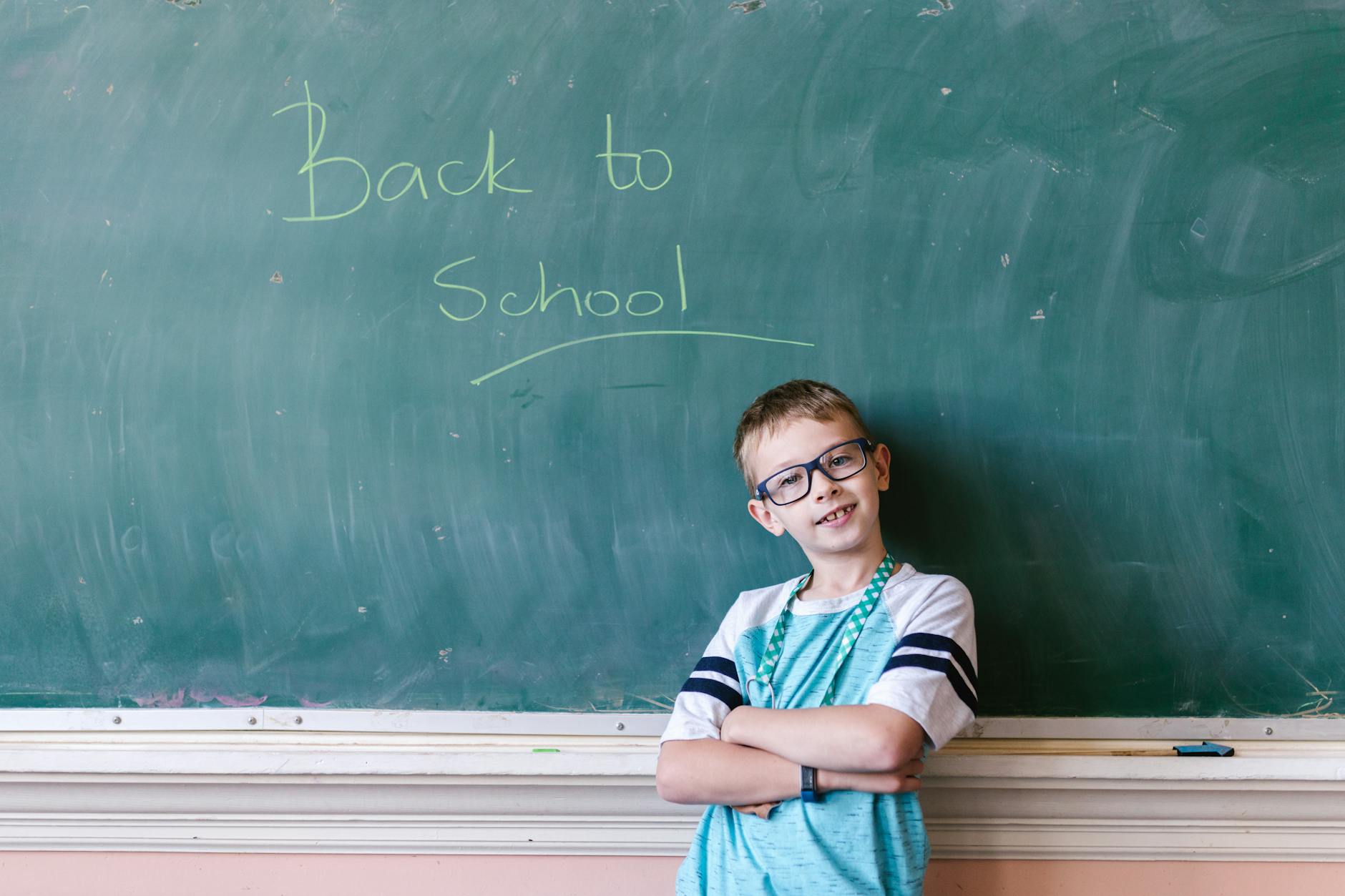 boy leaning on the blackboard