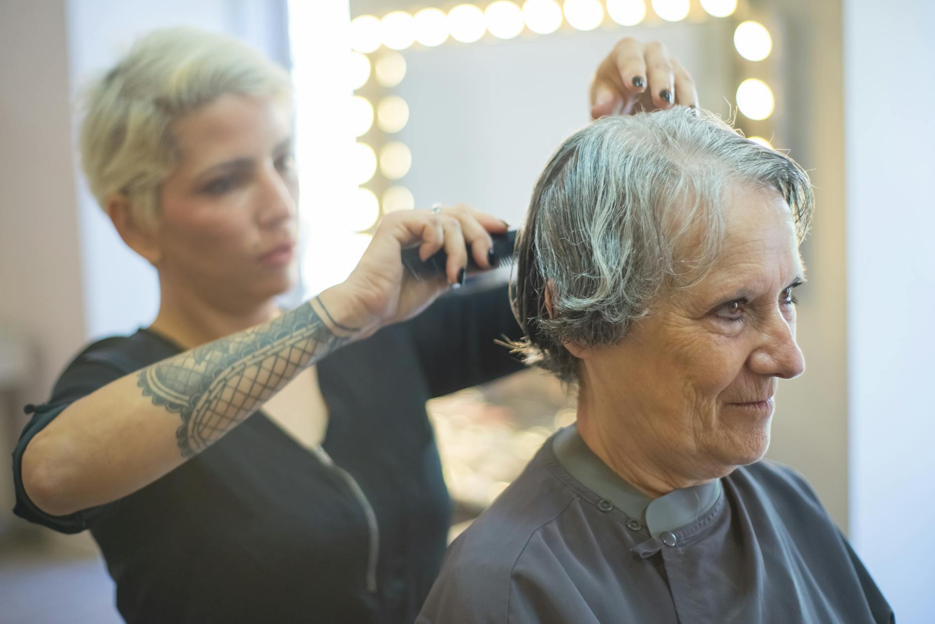 an elderly woman having her hair cut