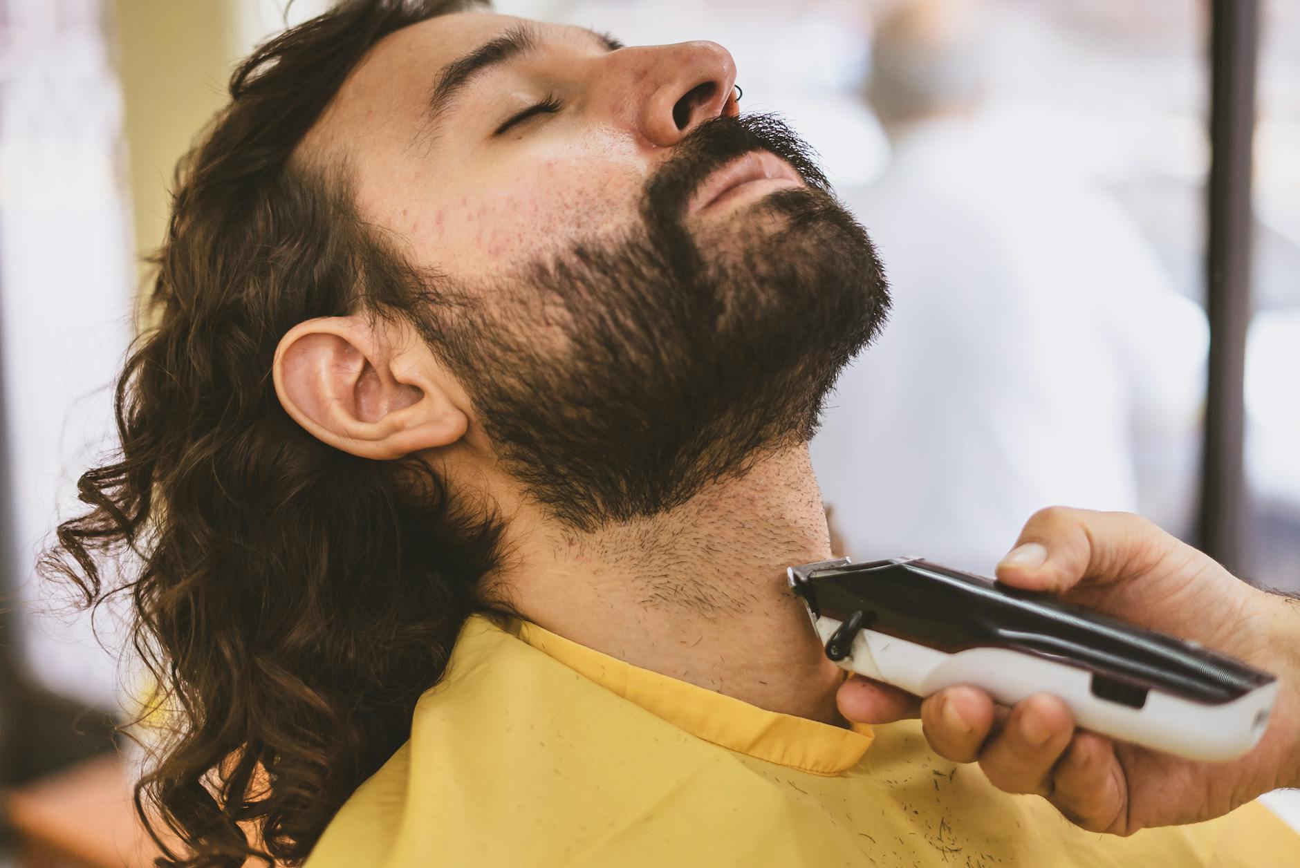 Stache – Mustache Trimming: The Year of the "Intentional Lip" at Just For Hair 1 barber shaving a man s beard with hair clipper