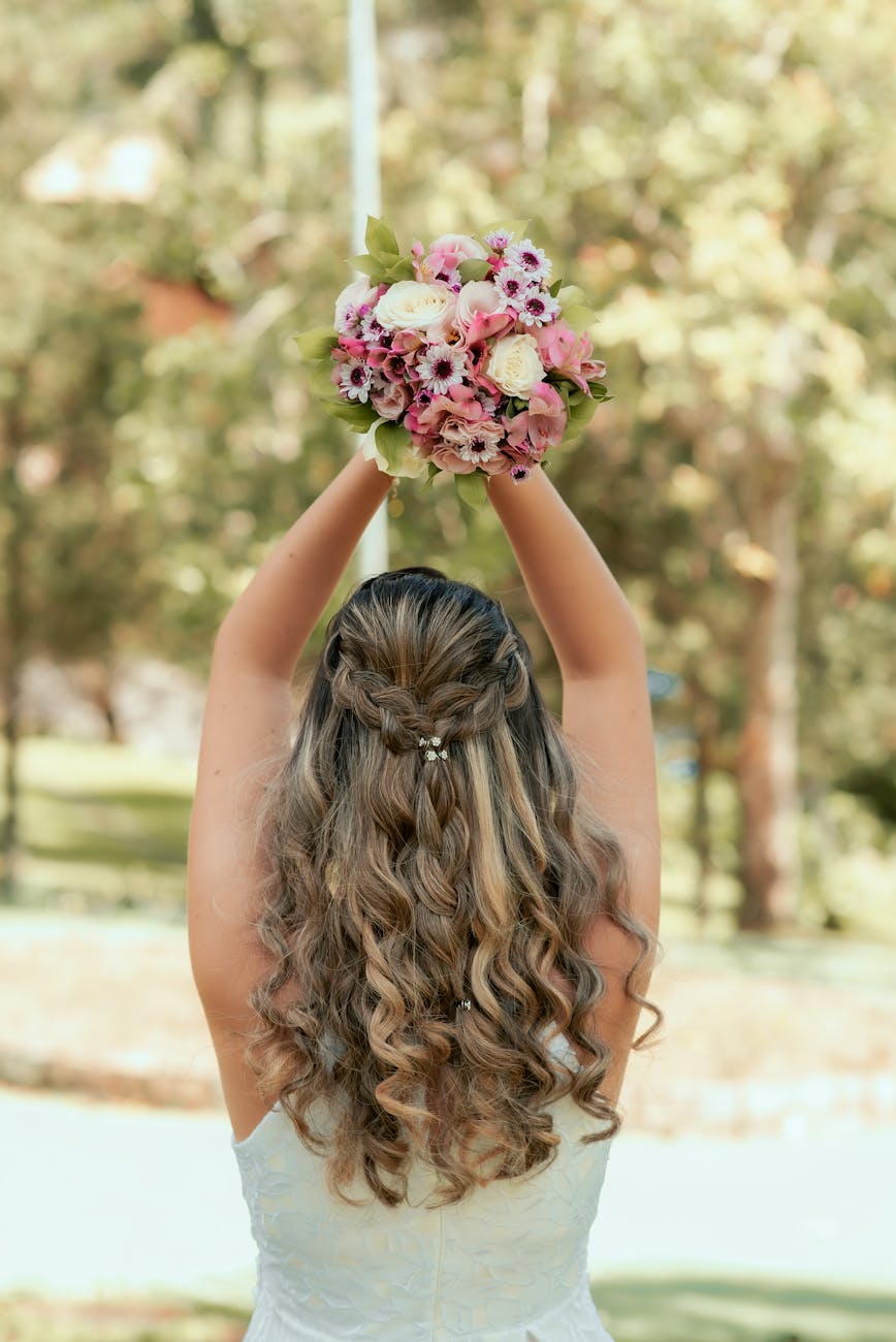 back view of a woman holding wedding bouquet