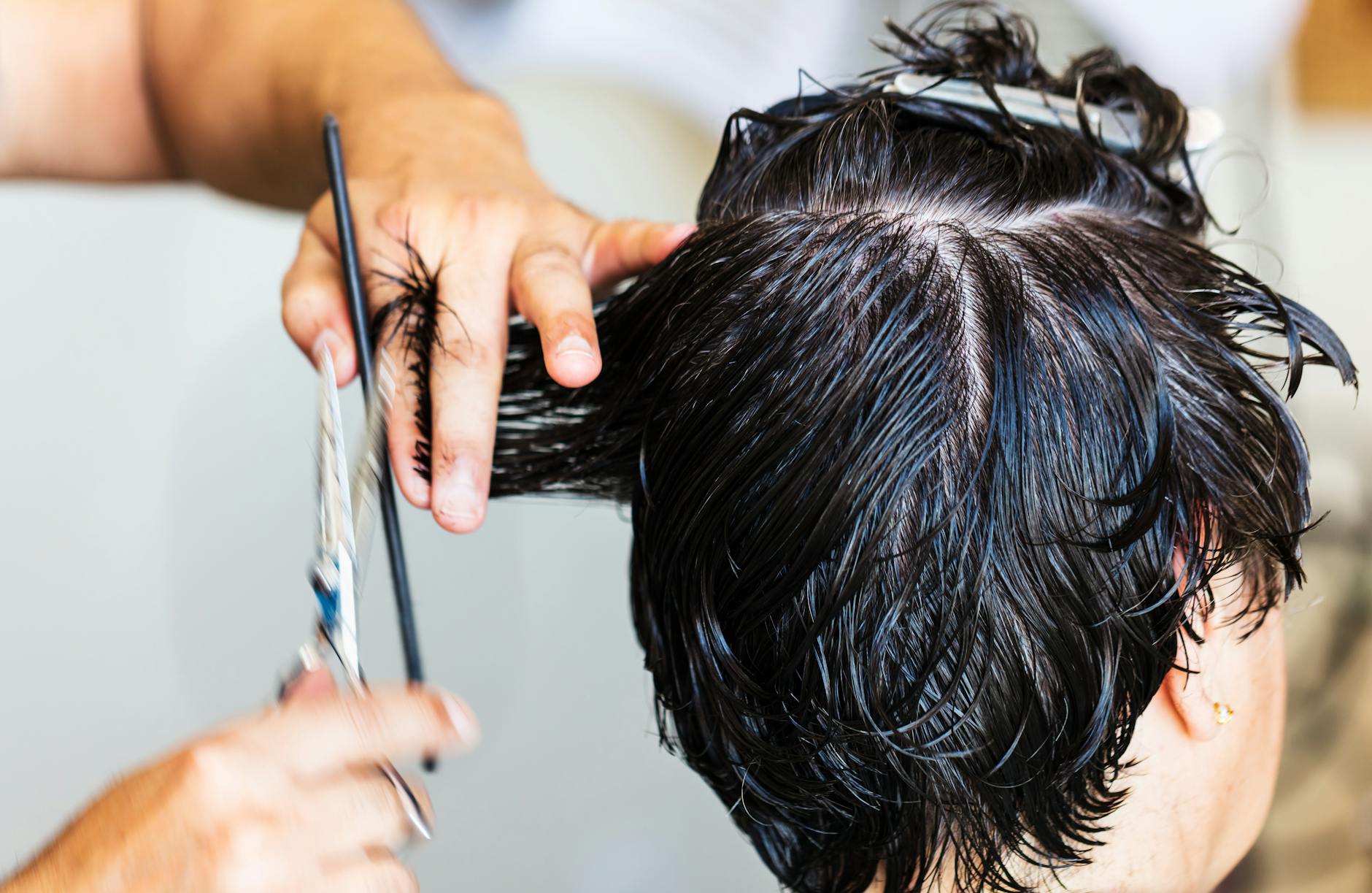 close up of person with short hair getting a haircut