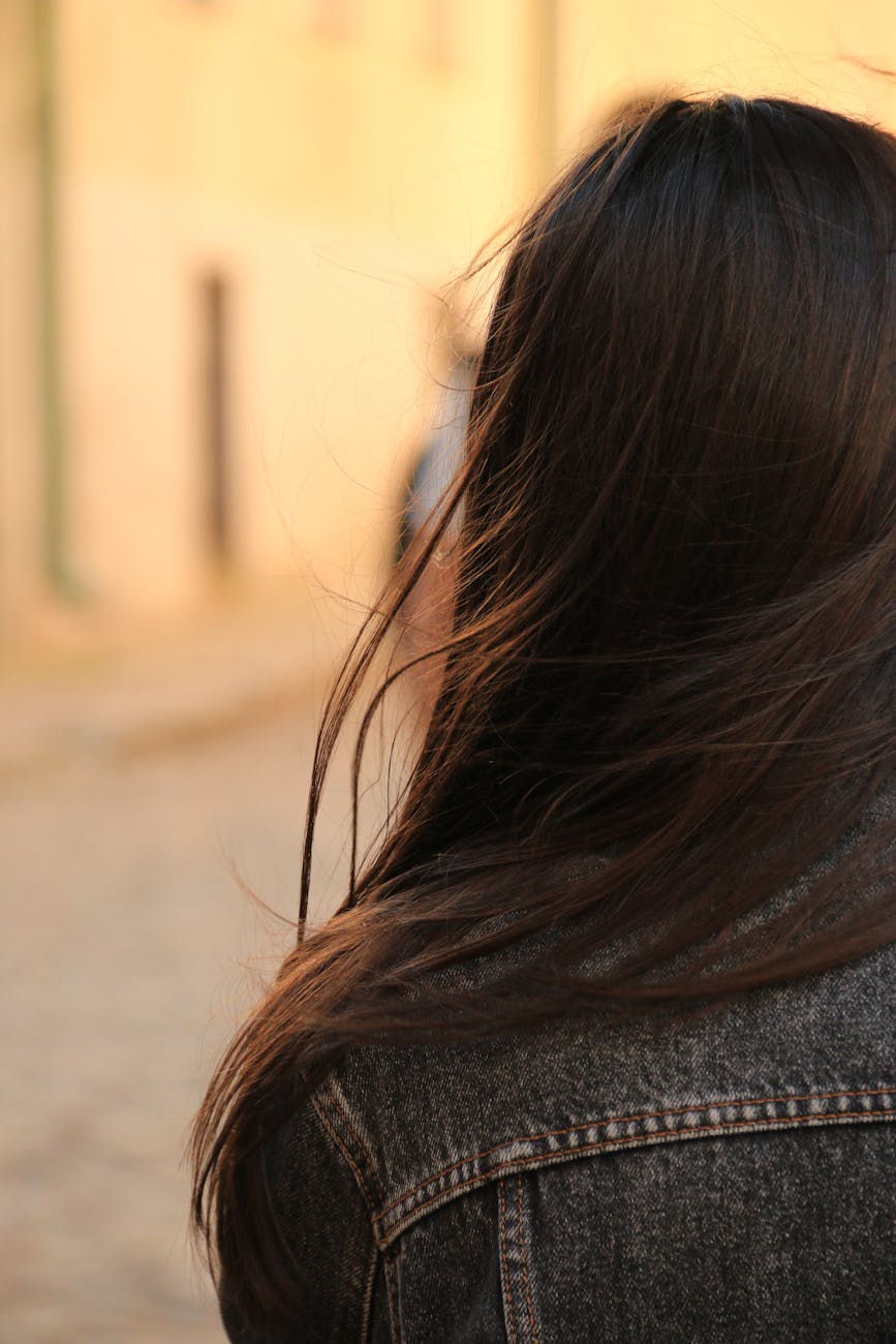Caramel Ribbon Highlights for Deep Brunette Hair 1 brunette woman in denim jacket
