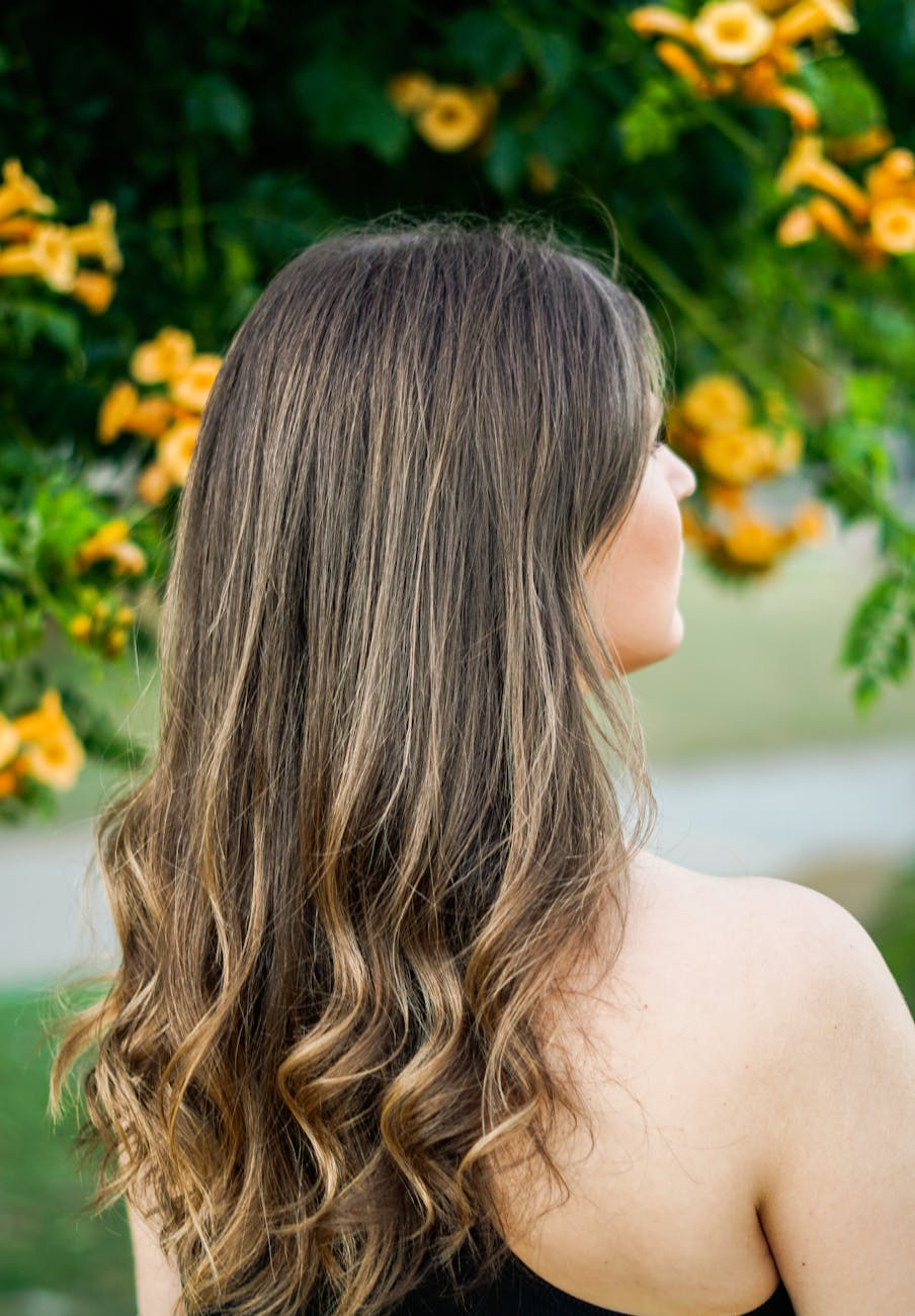 Soft Dimensional Brondes: The Perfect In-Between Shade 1 long haired woman posing close to flowers on tree