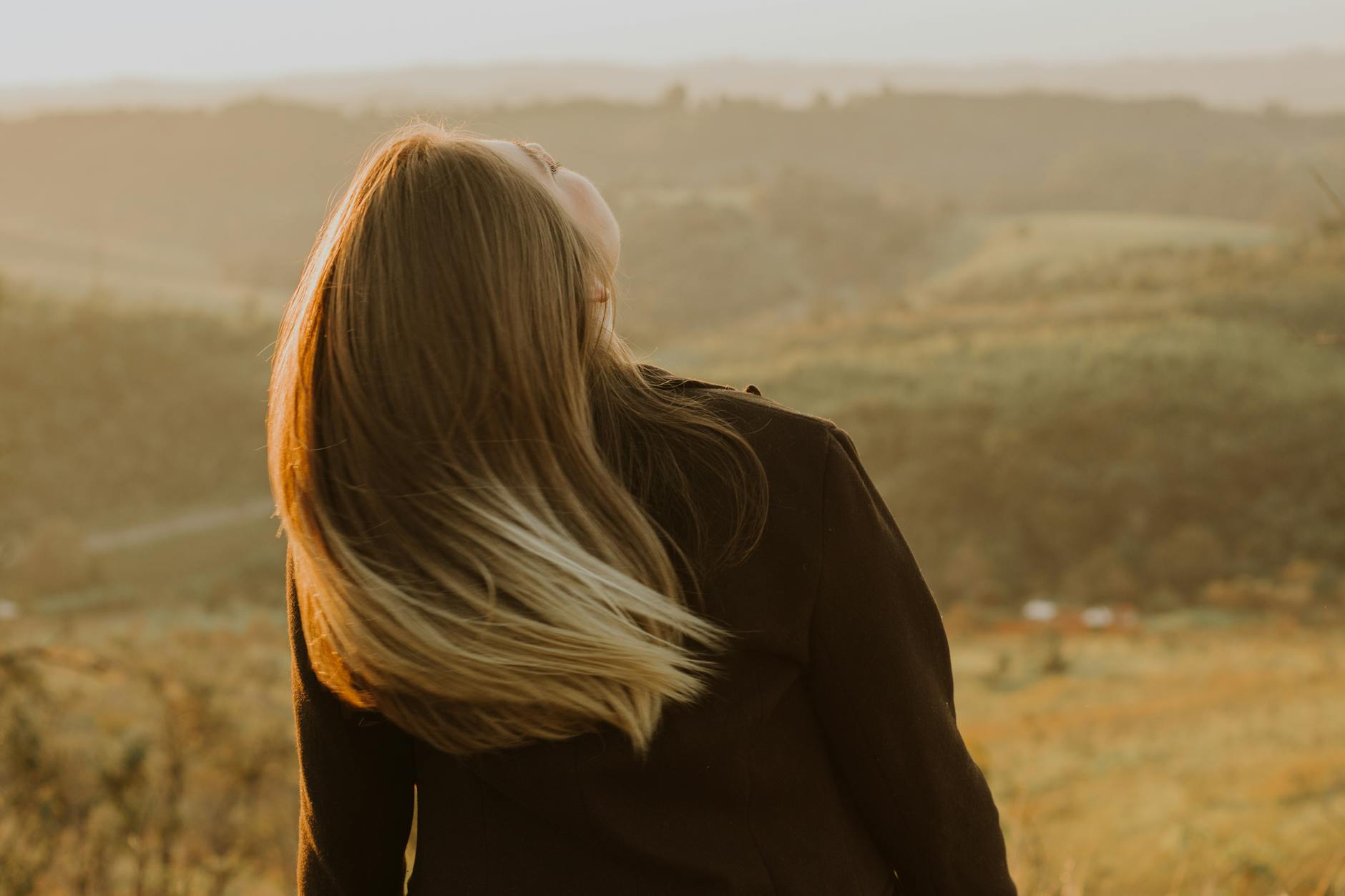 back view of blonde woman on field