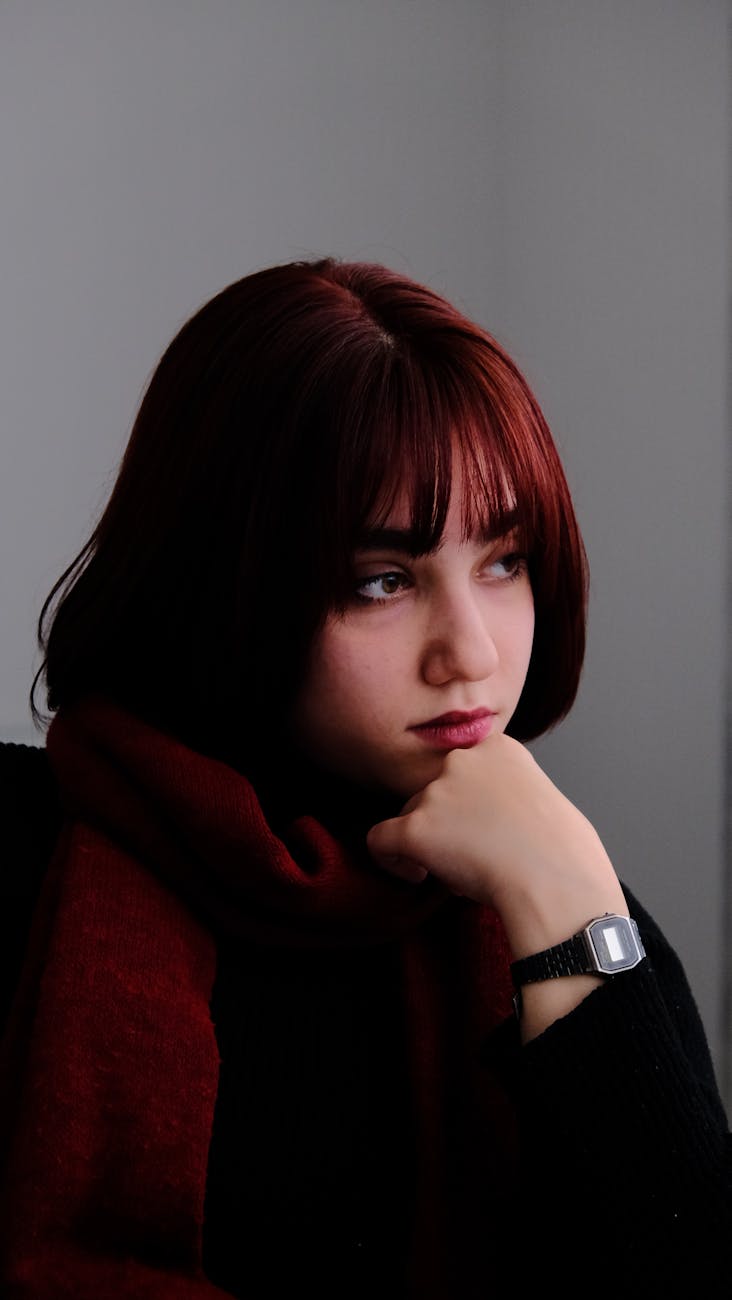 thoughtful woman in red scarf portrait