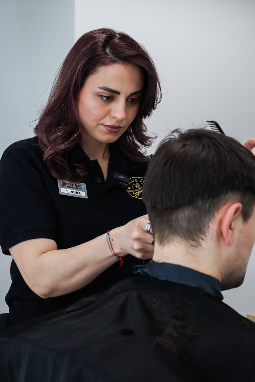 The Executive Edge: Men’s Haircuts for a Stylish Professional Appearance 1 professional hairdresser cutting client s hair