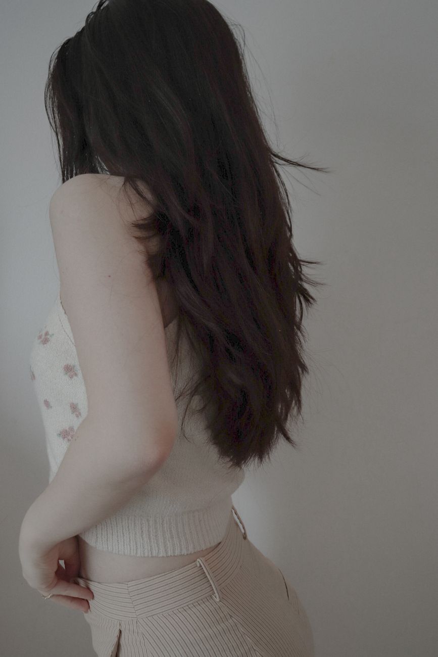 The Feathered Cut: Reviving 70s Volume with Modern Precision 1 unrecognizable woman wearing a beige top