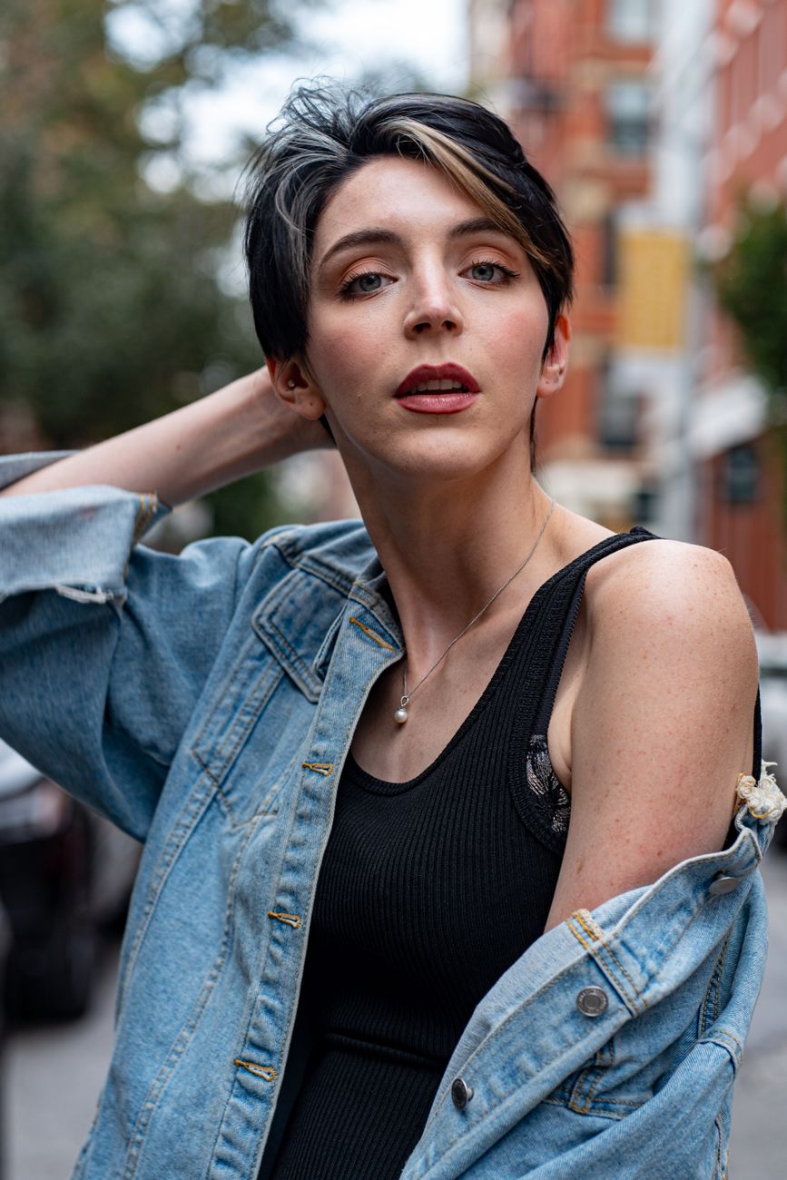 The Tapered Pixie: Clean Lines and Feminine Contours 1 a woman wearing denim jacket posing at the camera