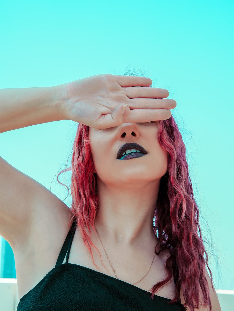 a woman covering her eyes
