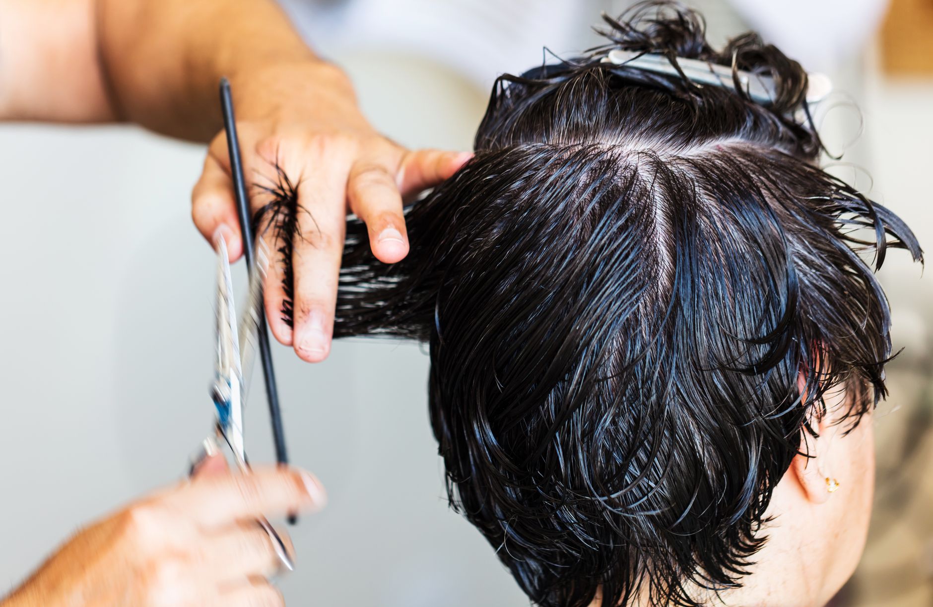 close up of person with short hair getting a haircut