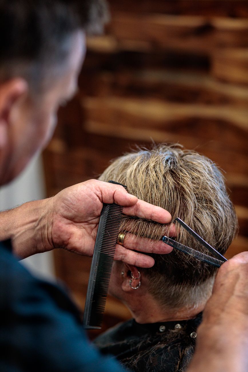 Pixie Cuts: Bold, Short Styles Tailored to Your Features 1 a person getting their hair cut