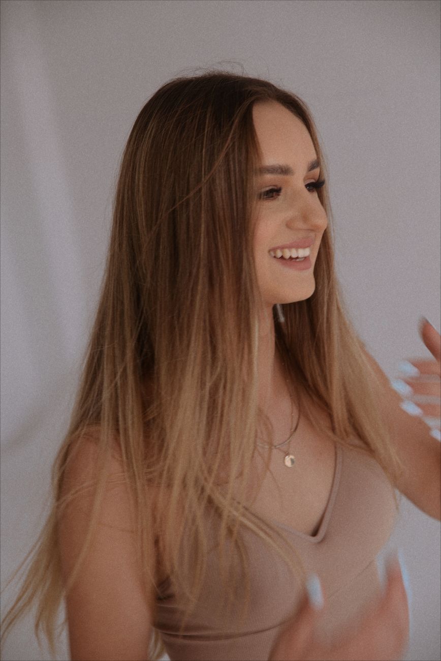 a woman with long hair is smiling