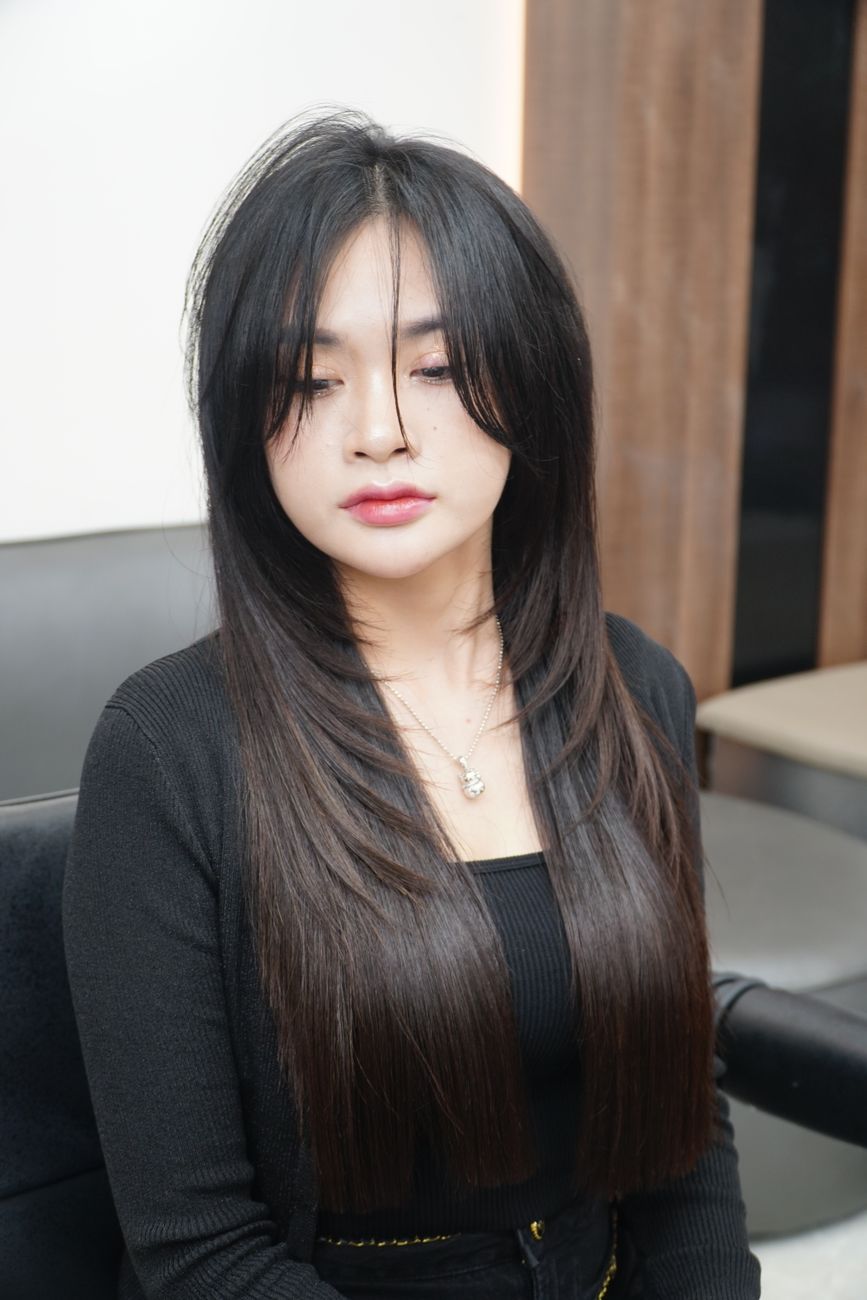 young woman with long straight hair in salon