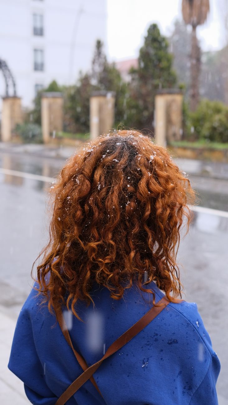 Demystifying Cold Wave Perms at Just For Hair Salon 1 woman with curly hair in winter on istanbul street