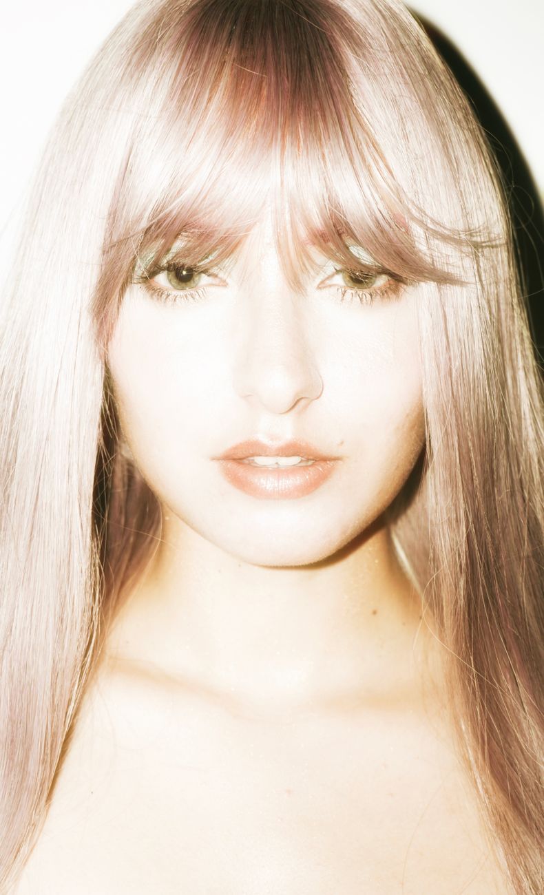 Wispy Bangs 101: Low-Commitment Fringe for Beginners 1 high key portrait of woman with pink hair