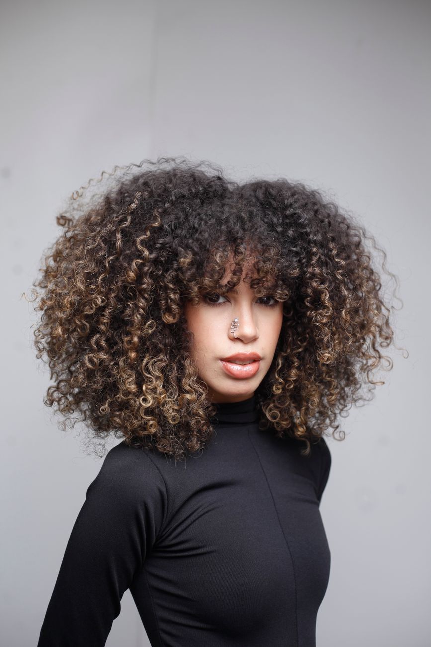 portrait of woman with curly hair and nose ring
