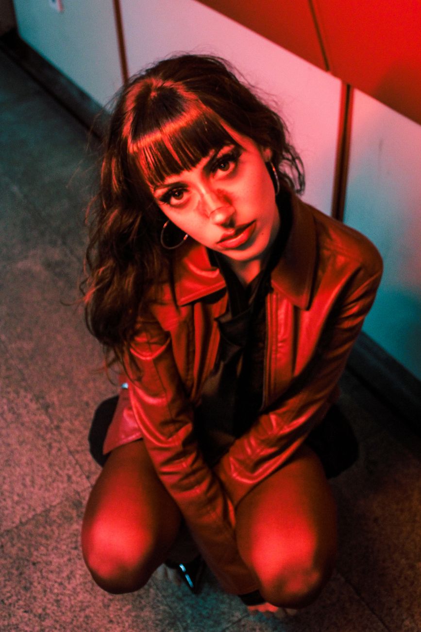 Micro Fringe: The Edgy Trend for Bold Style Statements 1 moody portrait of woman in red leather jacket