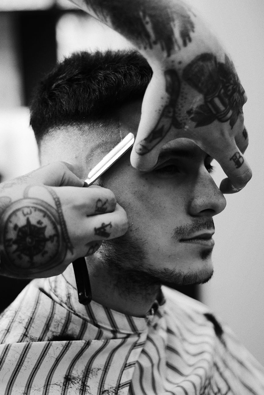 a barber cutting a man s hair