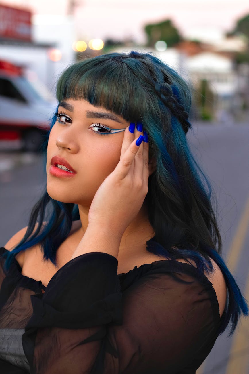 a woman in black off shoulder shirt with blue hair
