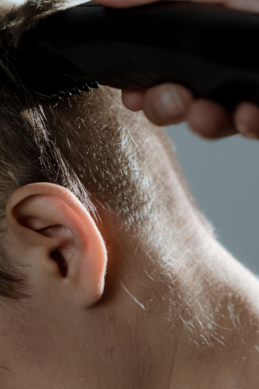 The Power of the Blunt Fringe for Boosting Fine Hair Volume 1 a person holding a razor