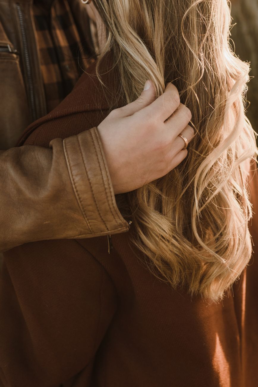 Engagement Photo Prep: When to Refresh Your Balayage for the Perfect Shot 1 man in brown leather jacket touching a blonde hair